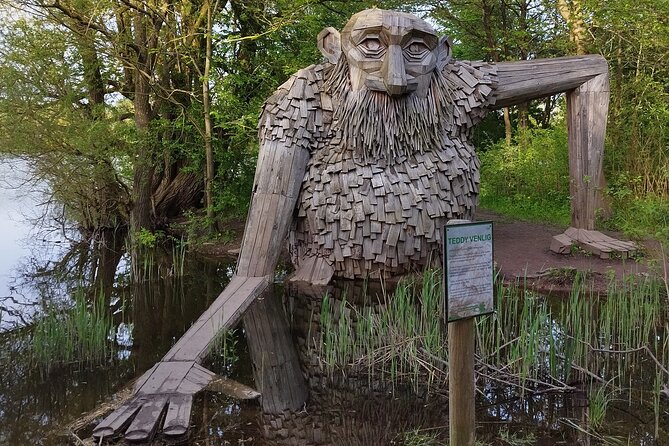 The Six Forgotten Giants Trolls Hunt with Minibus - Stop 2 (Rødovre): Sleeping Louis, trees around him, and a mouth you can enter